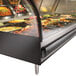 An Alto-Shaam 72" heated display case on a counter with food in it.