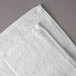 A close-up of a white Oxford Vicenza bath towel with a dobby border.