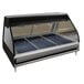 An Alto-Shaam heated display case with three trays inside on a counter.