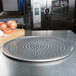 An American Metalcraft Super Perforated Heavy Weight Aluminum Coupe Pizza Pan with holes in it.