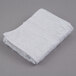 A white Oxford hand towel with a cam border on a gray surface.