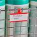 Metro red label holder attached to a metal rack with containers.