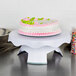 A cake on a white Wilton revolving cake stand.
