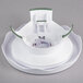 A white plastic cake turntable with green accents.