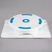 An Ateco white and blue plastic revolving cake stand with blue circles.