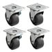 A set of 4 black rubber plate casters with steel plates.