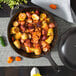 A Lodge cast iron skillet filled with food on a table.