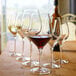 A group of Stolzle Exquisit Chardonnay wine glasses on a table.