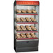 An Alto-Shaam heated display case with food on 4 shelves.