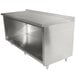 A stainless steel Advance Tabco cabinet base work table with a backsplash on a counter.