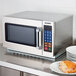 The silver door handle of a Solwave commercial microwave.