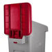 A grey and red plastic Rubbermaid Slim Jim recycling container with a red lid.