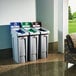 A group of Rubbermaid Slim Jim recycling trash cans with a blue rectangular lid insert.