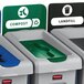 A group of Rubbermaid Slim Jim recycling bins with labels for different materials.
