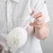 A person holding a white Franmara Glassware Washing Brush with a round white foam head.