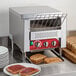 An Avantco conveyor toaster with toast on a plate.