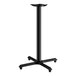 A black Lancaster Table & Seating bar height table base with a cross-shaped bottom.