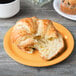 A croissant on a GET Tropical Yellow melamine plate.