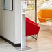 A white Purell floor stand with a silver panel.