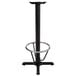 A Lancaster Table & Seating black cast iron bar height table base with a metal foot ring.