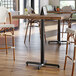A Lancaster Table & Seating black bar height table base with a black pole.