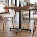 A Lancaster Table with a black cast iron base in a restaurant.