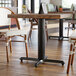 A Lancaster Table with a black cast iron column base.