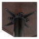 A black metal Lancaster Table & Seating table base with a black metal post.