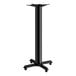 A black Lancaster Table & Seating cast iron bar height column table base.