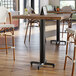 A Lancaster Table & Seating black bar height table base with a black pole.