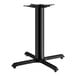 A Lancaster Table & Seating black cast iron table base with four legs.