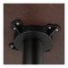 A Lancaster Table & Seating black cast iron bar height column table base with metal bolts on a black pole.