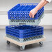a hand reaching for a blue and grey plastic basket