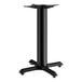 A Lancaster Table & Seating black cast iron table base with four legs.