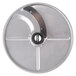 A circular metal Berkel slicing plate with a hole in it.