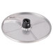 A circular metal plate with a black handle.
