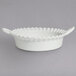 A white G.E.T. Enterprises deep Mexican cazuela bowl with a wavy edge.