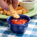 a close up of a finger holding a potato chip