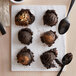 A spoon with David's Cookies Triple Chocolate Brownie with HERSHEY'S Kisses Edible Cookie Dough on it.