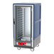 A blue and silver Metro C5 heated holding cabinet with clear doors on wheels.