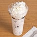 A WNA Comet Classic Crystal parfait cup filled with ice cream and topped with whipped cream.