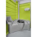 A lime green and grey PolyJohn portable restroom with a toilet.