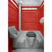 A PolyJohn red portable restroom with a translucent top.