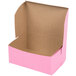 A pink bakery box with the lid open.