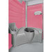 A PolyJohn pink and grey portable restroom with a sink.