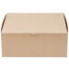 A close-up of a brown Kraft cake box with a lid.