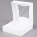 A white box with a clear plastic window on the lid.