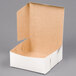 A 7" x 7" x 3" white bakery box with the lid open.