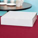A white bakery box on a table.