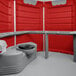 A PolyJohn wheelchair accessible portable restroom with a grey toilet and a black lid.